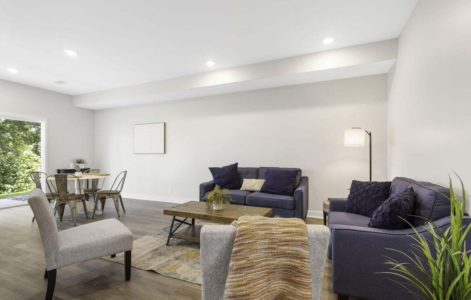 Spacious family room with contemporary seating and recessed lighting