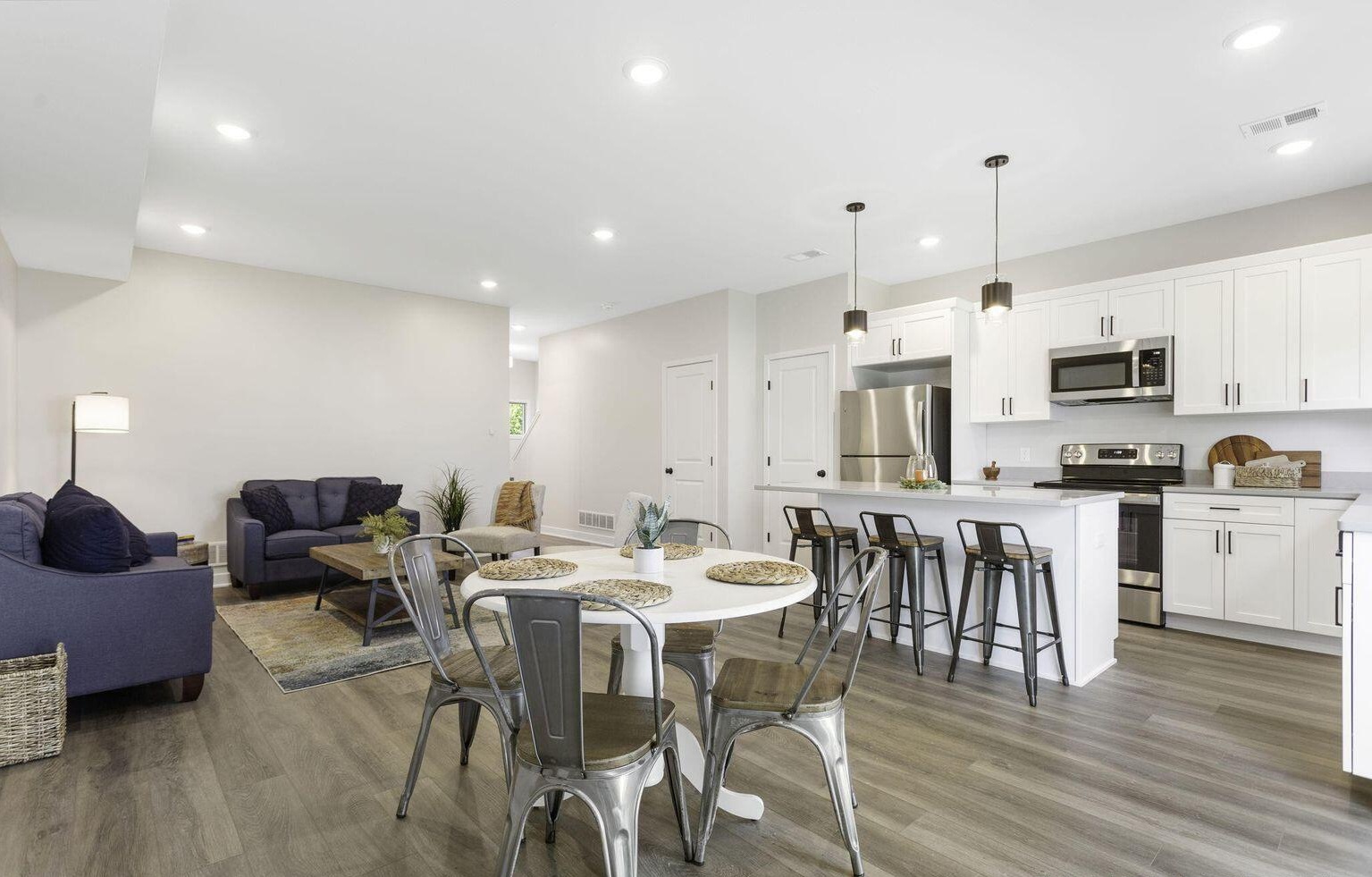 Contemporary white kitchen with large island and pendant lighting