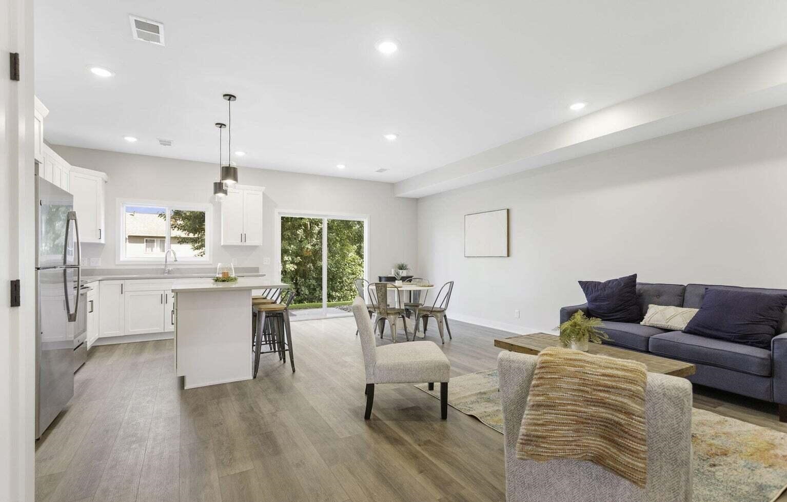 Bright living room at Signature Estates with modern seating, wood-look flooring and an open-concept layout