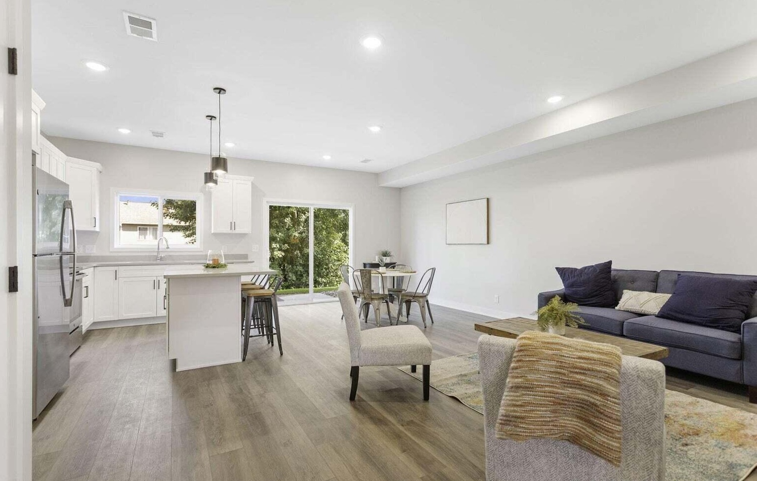Open-concept living, dining, and kitchen space at Signature Estates