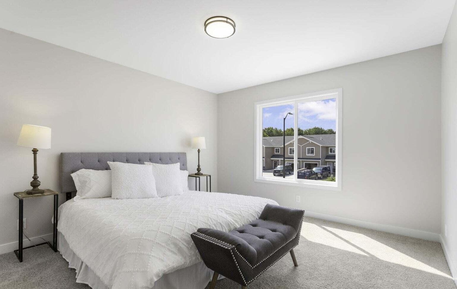 Primary bedroom with large window at Signature Estates