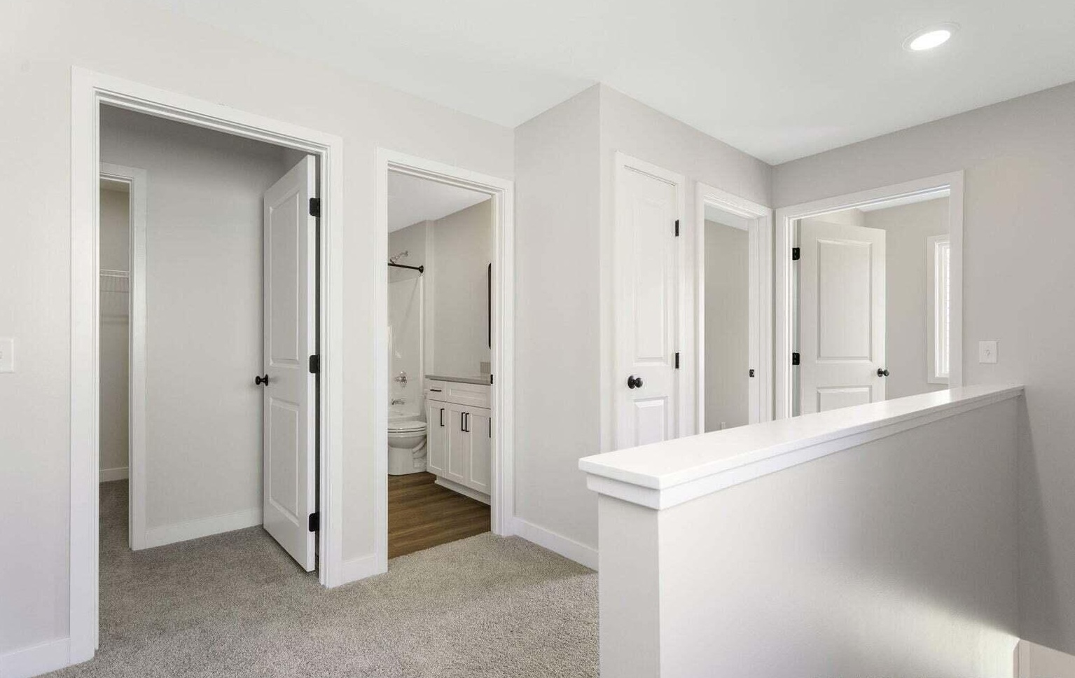 Upper-level landing with bright neutral finishes and white interior doors