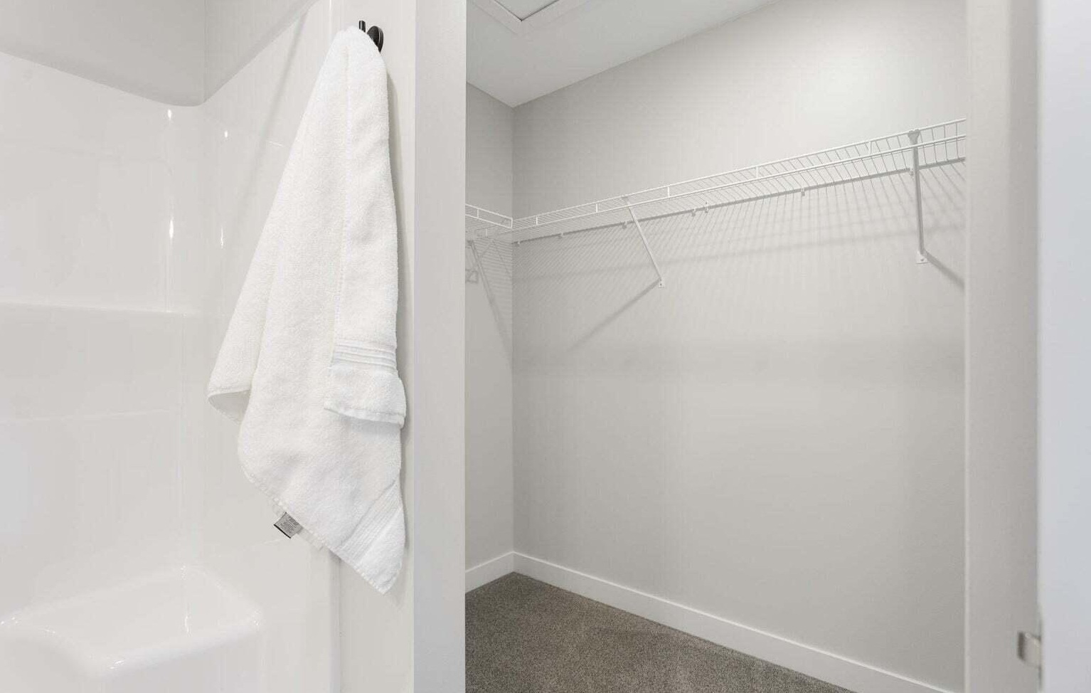 Walk-in closet with built-in shelving in a Signature Estates townhome